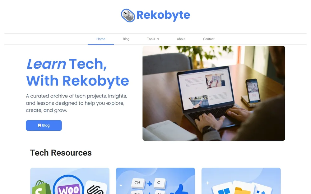 Rekobyte's old homepage: centered logo, plain white hero and a laptop photo